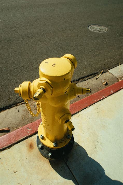 If a hydrant is inoperable, it should be painted black, but if it's only temporarily unusable, a black bag should be placed over it. Yellow Fire Hydrant on Street · Free Stock Photo
