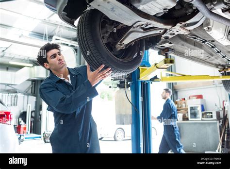 Mechanic Fixing A Car Wheel Stock Photo Alamy