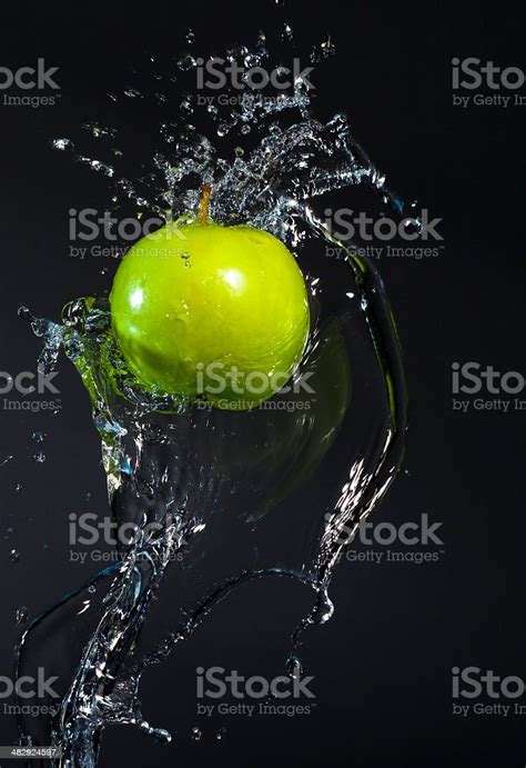 Green Apple Splash With Clean Water With Black Background Stock Photo