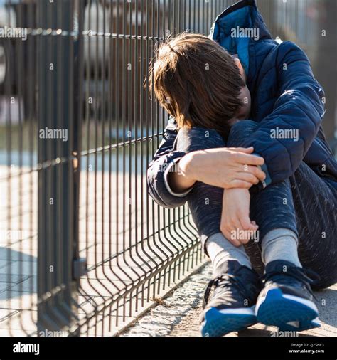Sad Boy Sitting And Crying On Street Negative Emotion Stock Photo Alamy