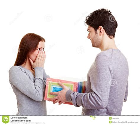 What you give and how you give it can make you seem low value or high value in a man's mind. Man giving woman a gift stock photo. Image of gift ...