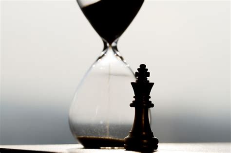 Hourglass And Chess Pieces Accumulation And Passage Of Time Stock Photo