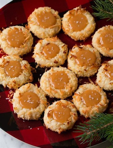 Cookies With Caramel Sauce On A Red And Black Plate Next To Christmas