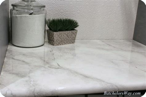 Start painting by dipping the sea sponge into the lightest gray paint and dabbing it on to create the light/dark marble variations. Remodelaholic | $30 DIY Faux Marble Countertops