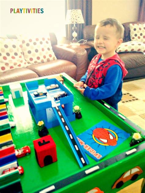 This cardboard parking garage for toy cars is an absolute must if you have any car loving little ones! DIY Toy Car Garage Table That Cost Almost Nothing To Make | Diy toys car, Toy car garage, Diy toys