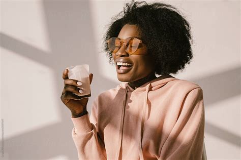 Cheerful Black Female Eat Milk Del Colaborador De Stocksy Sergey