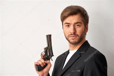 Handsome Man Holding A Gun — Stock Photo © Yacobchuk1 102474444