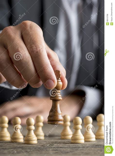 Businessman Playing Chess Moving Black King Piece Lifting It Up Stock