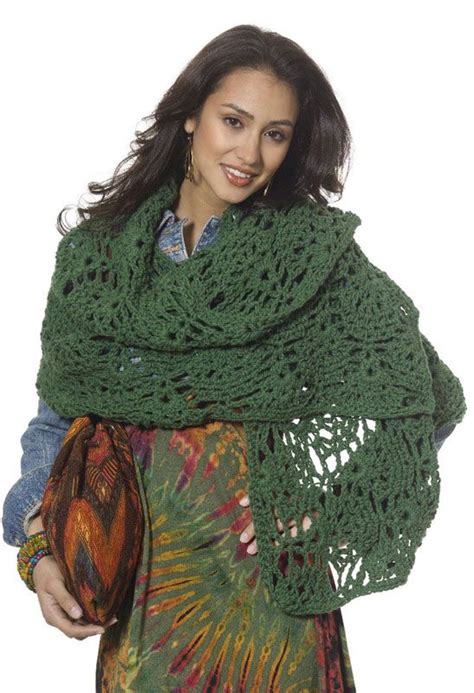 A Woman Wearing A Green Crocheted Shawl And Smiling At The Camera With