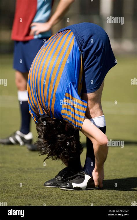 Soccer Player Stretching On Field Stock Photo Alamy