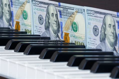 A Row Of One Hundred Dollar Bills In Front Of Piano Stock Image Image