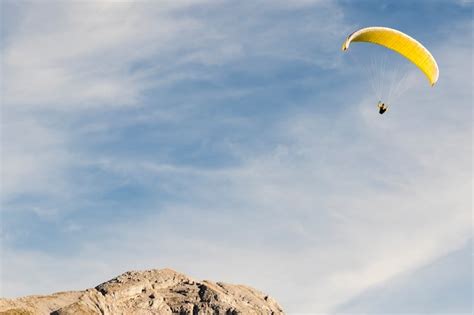Premium Photo Paragliding In The Blue Sky