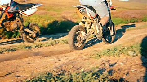 Motocross Biker On Powerful Enduro Motorcycle Starting Kicking Up Dust
