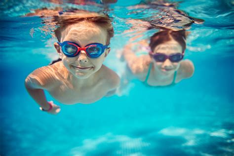 Happy Kids Swimming Underwater In Pool Stock Photo Download Image Now