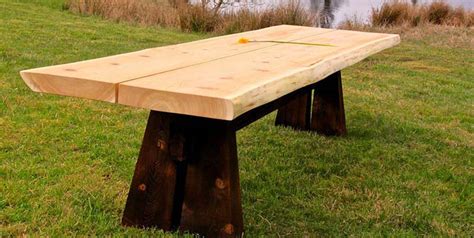 Live edge walnut dining table with flat iron legs, walnut natural edge look. Cedar Slab Farm Table w/ Fire Blackened Base - Orcas Workshop