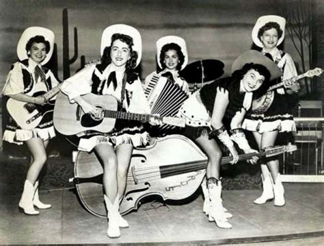 Four Women Are Posing With Guitars And Hats
