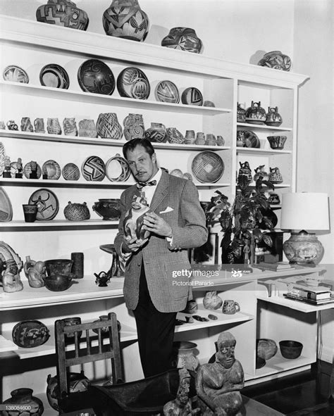 Vincent Price With A Display Of Ceramics From His Art Collection Circa
