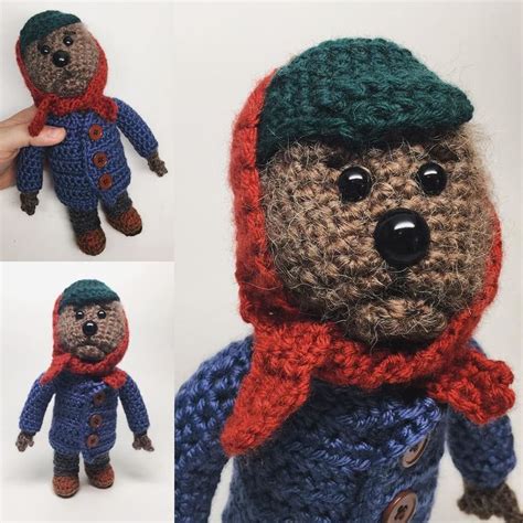 There Is A Crocheted Teddy Bear Wearing A Red Scarf And Green Beret