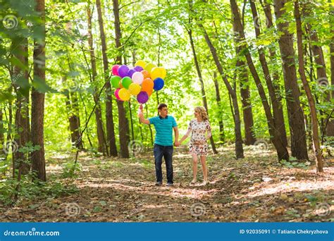 Young Couple Man And His Pregnant Wife With Balloons Outdoors Stock Image Image Of Health