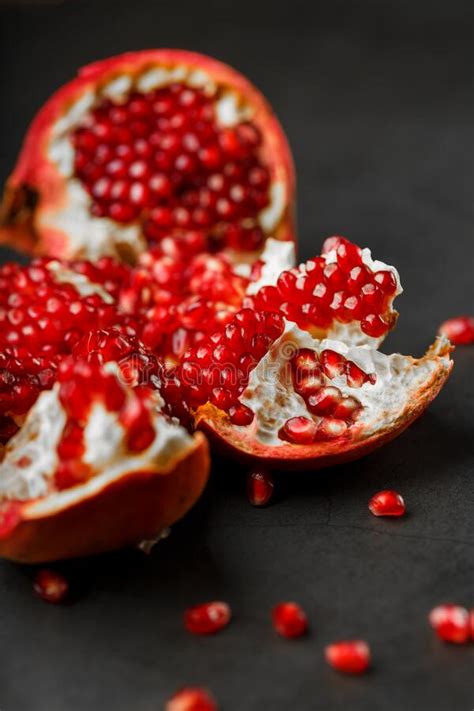 Juicy Seeds Of Fresh Fruit Of The Opened Pomegranate On A Black