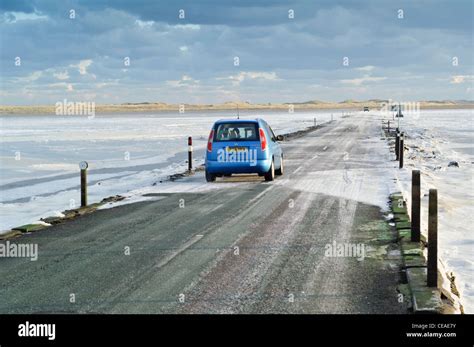 The Tidal Causeway Road Leading To Lindisfarne Holy Island With The