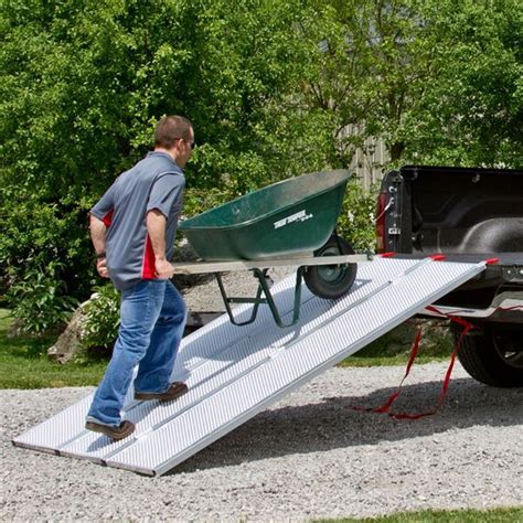 Pushing Wheelbarrow Into Pickup Truck Bed With Tri Fold Utility Ramp