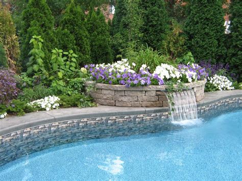 What can possibly be better than a swimming pool in your backyard landscape, a small pool waterfall to create that relaxing vibrant sound while you are enjoying your favorite beverage in a suspended outdoor bed or lounge chair? Raised planting area with waterfall - really cool stuff ...