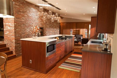 Modern kitchen design in the middle of the past century became affordable and attractive. Midcentury modern kitchen. Dark wood. Brick wall. Huge ...