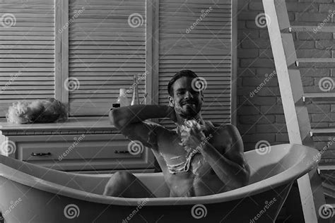 guy sitting naked in bathroom with toiletries and stairs on background sex and relaxation