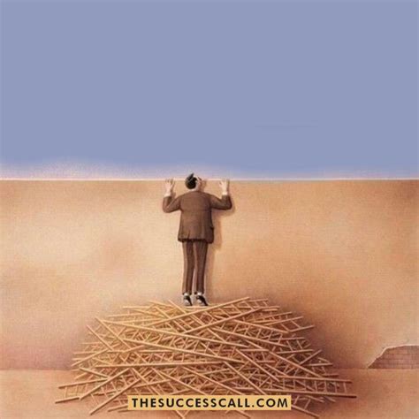 A Man Standing On Top Of A Pile Of Sticks In Front Of A Blue Sky