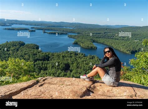 Woman Enjoying The View Of Squam Lake From West Rattlesnake Mountain Nh