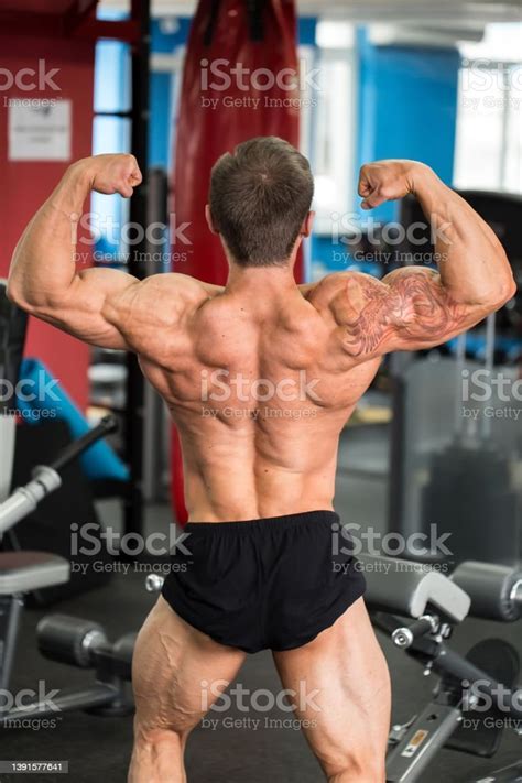 Male Bodybuilder Flexing His Biceps Back View Stock Photo Download