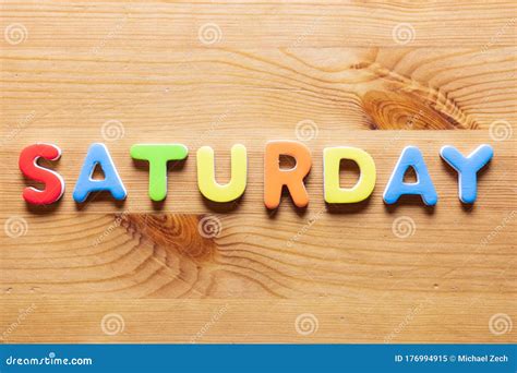Saturday Word Written With Colorful Letters On Wooden Table Background