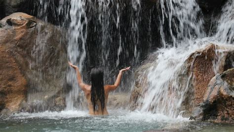 waterfall with woman in bikini bathing and swimming in natural pool on travel sexy beautiful