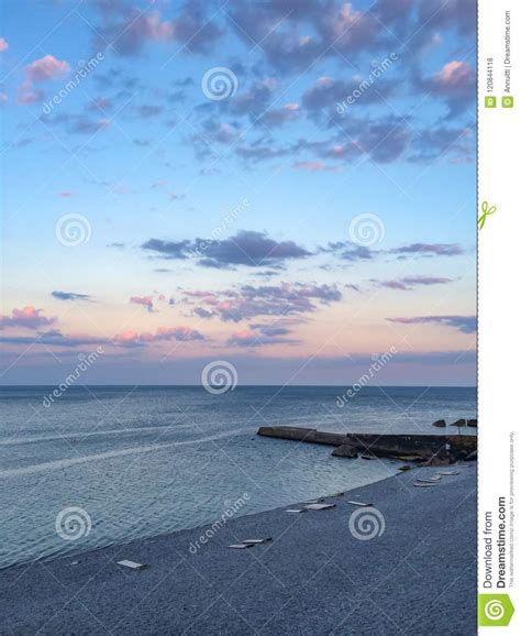 Beach At Sunset Sea And Blue Sky With Clouds Stock Photo