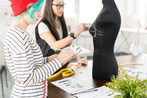 Two Creative Fashion Designers Working In Atelier Workshop Stock Photo