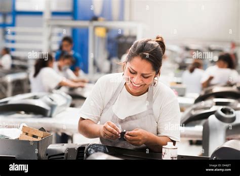 Worker Smiling In Manufacturing Plant Stock Photo Alamy