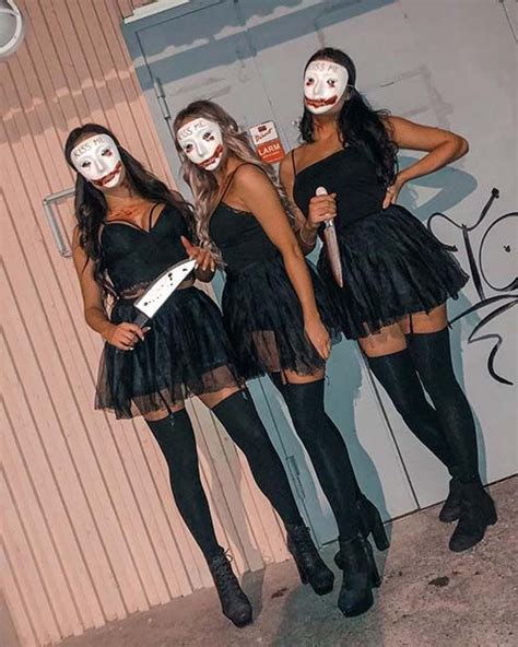 Three Young Women Dressed In Costumes Posing For A Photo With Their