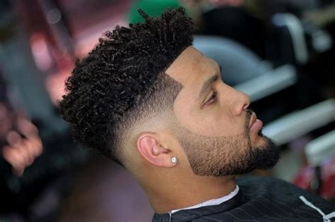 As the taper fade already graduates to a shorter length around ear level, why not just keep the fade going right through your sideburns into your beard? 11 Best Taper Fade Haircuts for Curly Hair - Cool Men's Hair