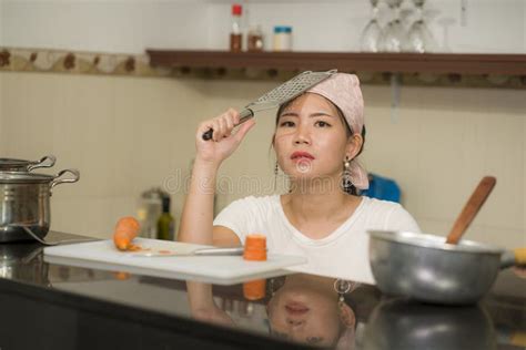 Beautiful Overwhelmed And Stressed Chinese Girl Working In Kitchen