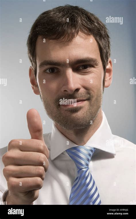 Businessman Giving A Thumbs Up Stock Photo Alamy
