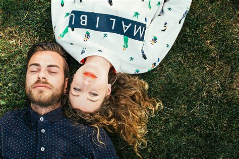 Young Couple Lying In The Grass By Stocksy Contributor Vera Lair Stocksy