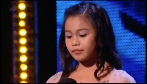 11 year old girl walks up on stage but everyone has stunned expressions on their face