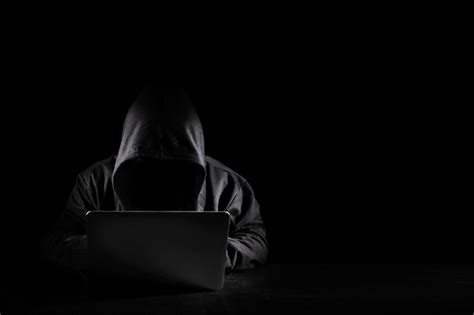 Premium Photo Dangerous Anonymous Hacker Man In Black Hooded Using
