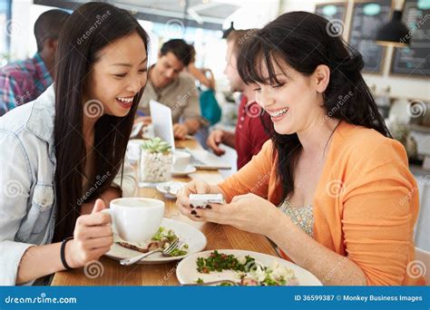 Two Female Friends Friends Meeting For Lunch In Coffee Shop Stock Image