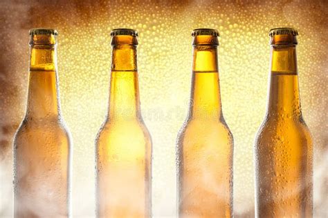 Row Glass Bottles With Beer With Golden Background And Steam Stock Image Image Of Background