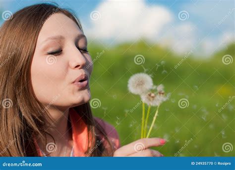 Beautiful Young Woman Blowing Dandelion Flowers Royalty Free Stock