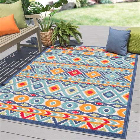 An orange and blue outdoor rug in your outdoor entertaining space gives a playful and energetic feel. New London Geometric Orange/Blue Indoor/Outdoor Area Rug ...