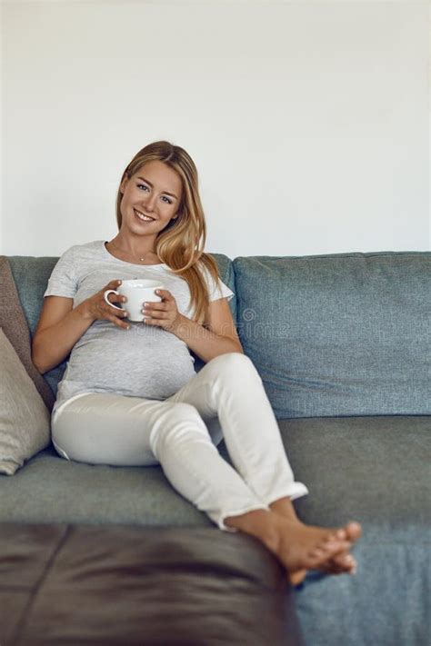 Pretty Barefoot Young Pregnant Woman Relaxing On A Couch Stock Image Image Of Drinking