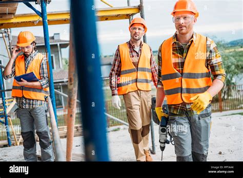 Group Of Builders Working Together At Construction Site Stock Photo Alamy